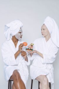 diverse women in sheet masks doing morning procedure for skin